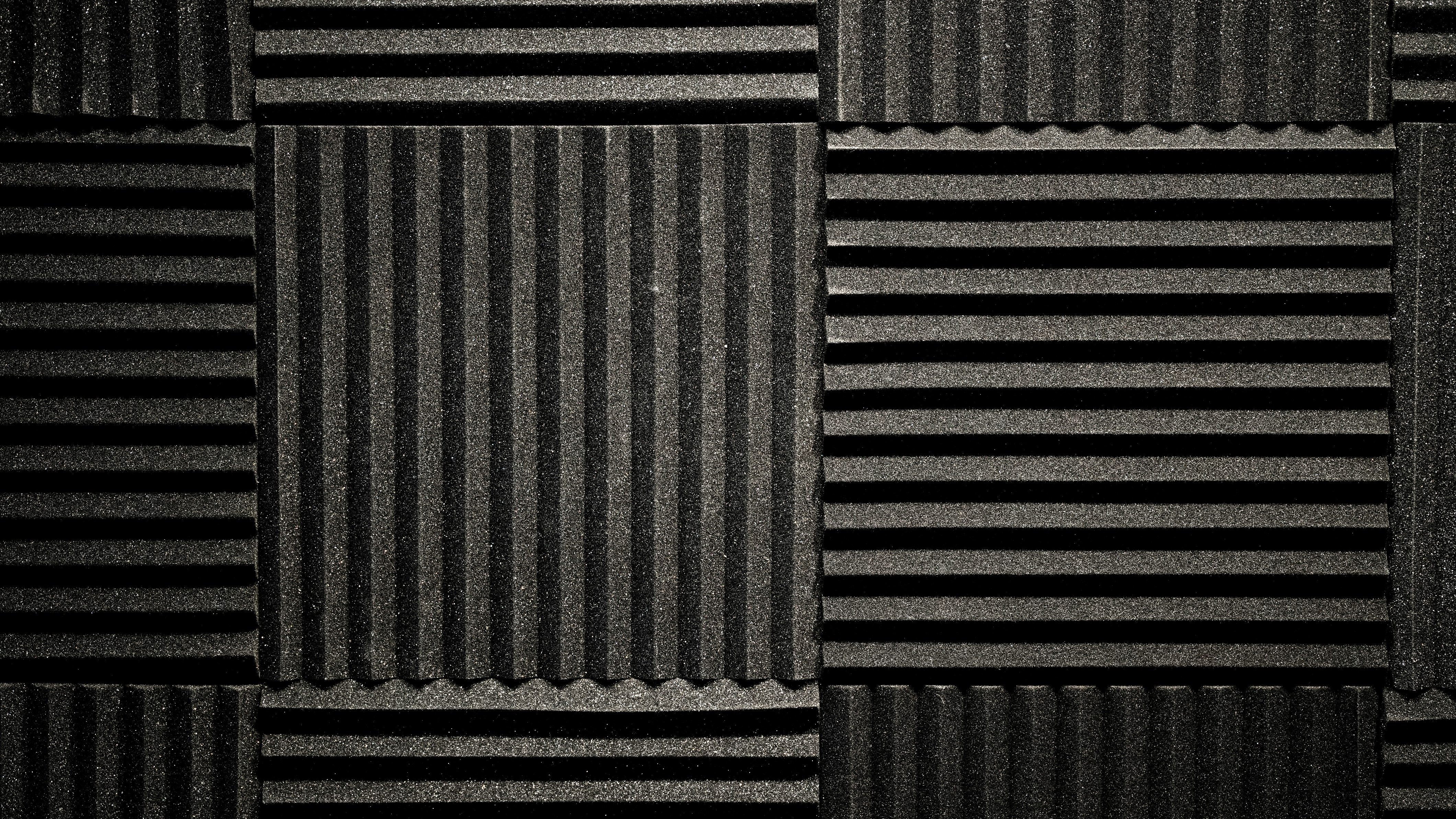 A foam sound panel black backdrop. Photo by 2H Media on Unsplash
